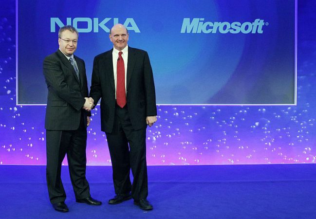 Nokia chief executive Stephen Elop welcomes Microsoft chief executive Steve Ballmer with a handshake at a Nokia event in London