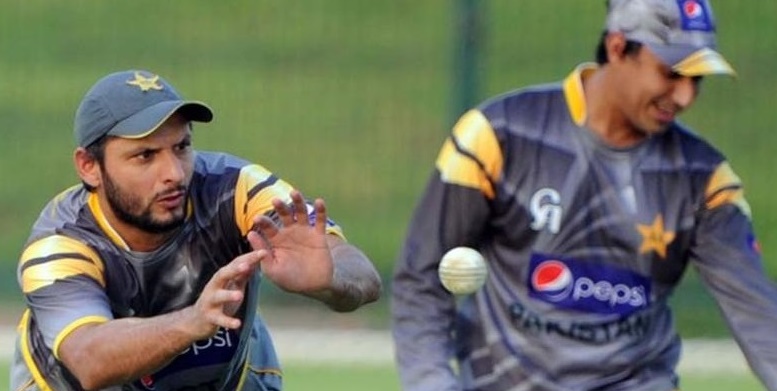 Pakistani cricketer Shahid Afridi (L) catches the ball during a training session at the Abu Dhabi stadium August 30, 2012. Australian captain Michael Clarke hopes his batsmen will continue to show improvement against Pakistani spinners when the teams clash in the second one-day in Abu Dhabi on August 31.  AFP PHOTO / AAMIR QURESHI        (Photo credit should read AAMIR QURESHI/AFP/GettyImages)