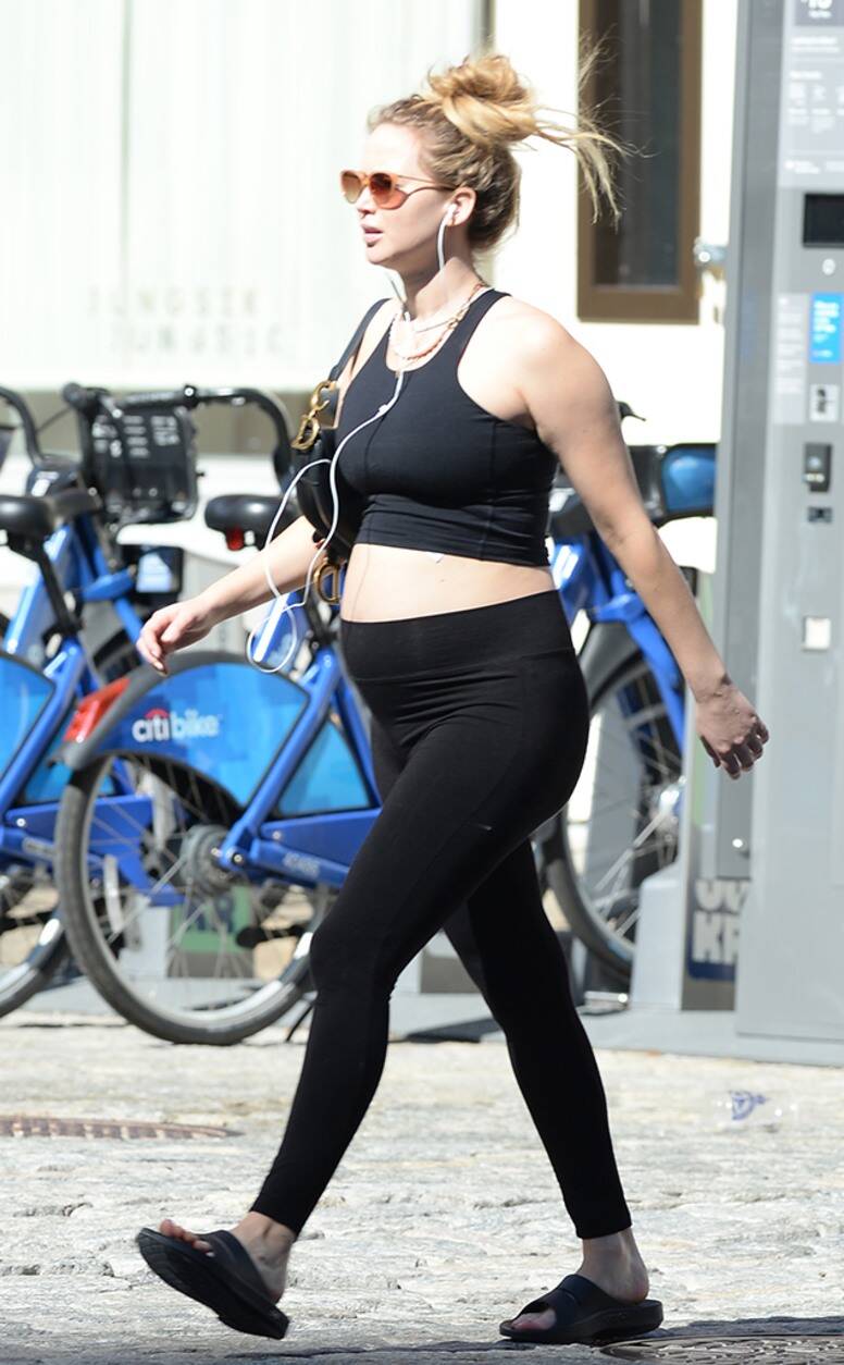 Pregnant Jennifer Lawrence flaunts her baby bump posing with Leonardo DiCaprio