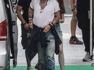 New flame? Johnny Depp appeared to be in a good mood as he arrived to a rehearsal at the Arena Santa Giuliana on Sunday in the presence of a red-haired mystery woman