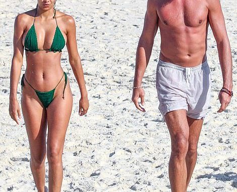 Summertime fun: Lais Ribeiro showed off her svelte figure in a tiny green string bikini as she soaked up the sun during a beach day with husband Joakim Noah