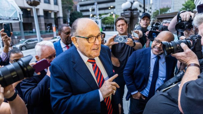 Man charged with assault for tapping Giuliani on the back signals potential $2m lawsuit for false arrest