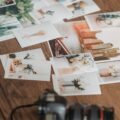 Printed photos scattered on wooden table