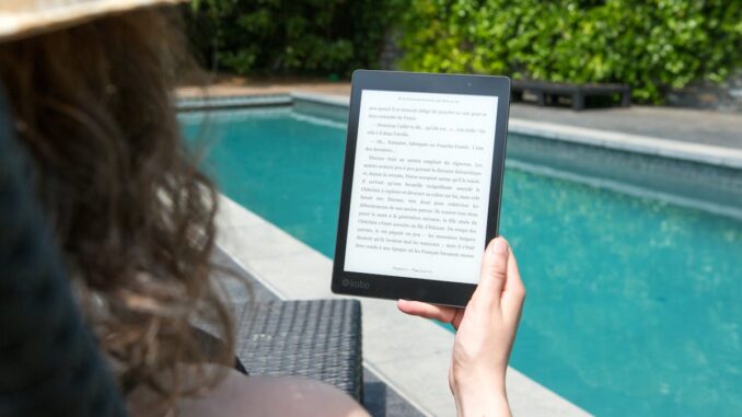 Woman Sitting Beside Pool Holding Tablet